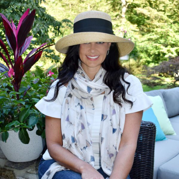 Woman in straw hat and patterned scarf.