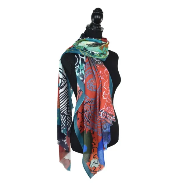 Colorful patterned shawl on mannequin.