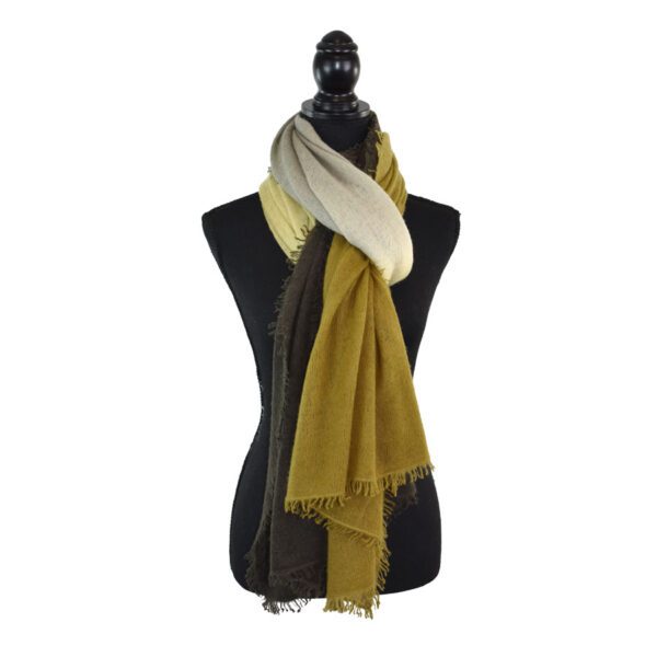 Black mannequin with a dual-colored scarf in beige and mustard yellow.