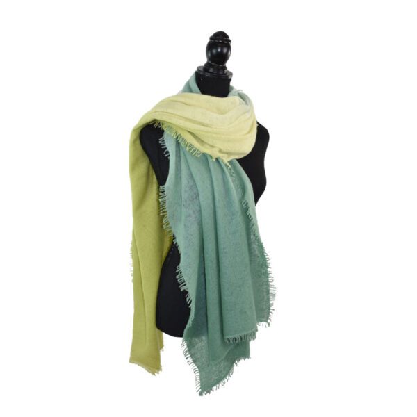 Mannequin draped with yellow and green scarves.