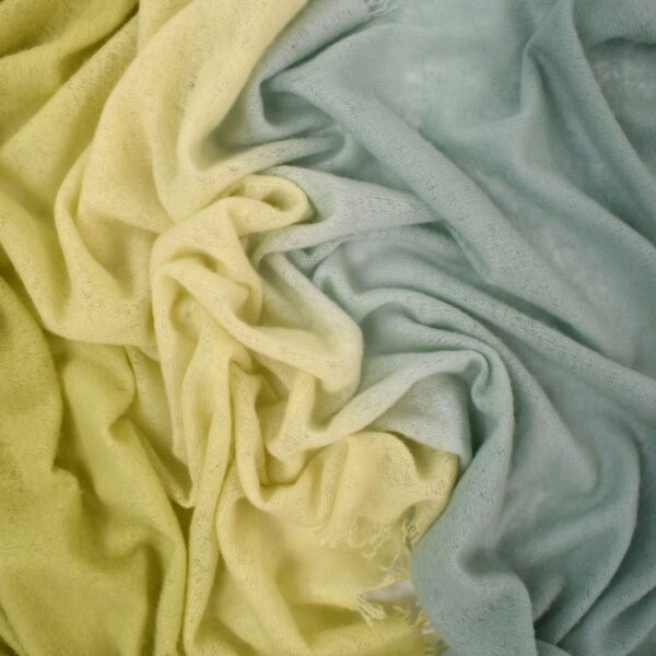 Soft fabric in pastel yellow and blue colors gently folded.