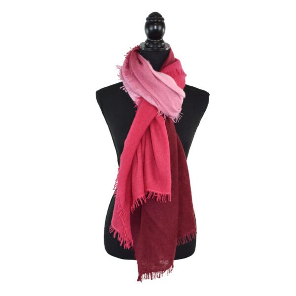 Black mannequin with a dual-tone pink and red scarf.