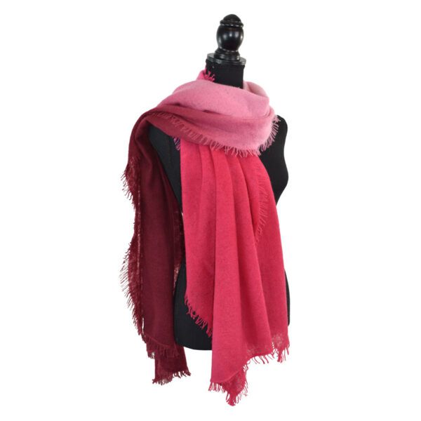 Elegant pink scarf displayed on a black mannequin.