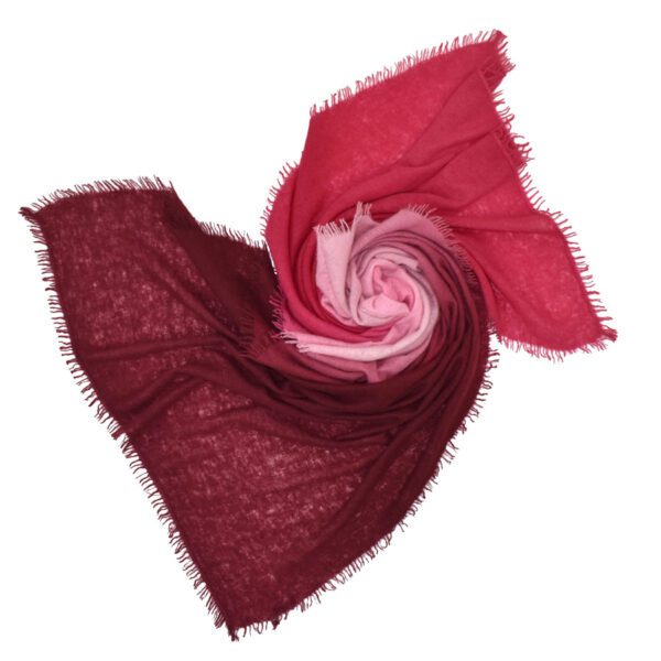 A red and burgundy scarf twisted into a heart shape.