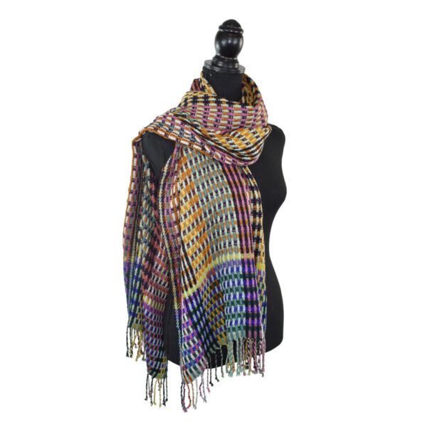 Colorful plaid shawl on mannequin.